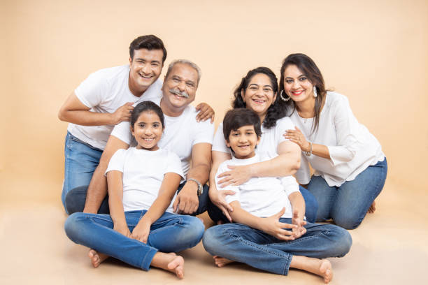 Happy Indian family sitting together on the floor